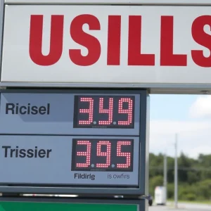 Gas station sign showing rising fuel prices.